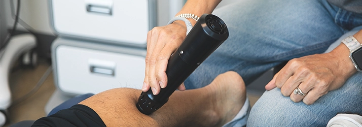 A shockwave device is applied to a person’s leg.